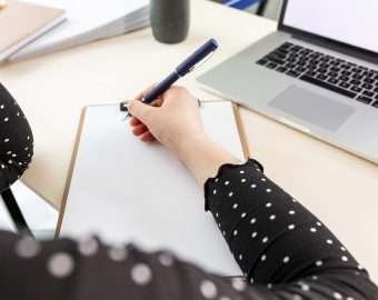 high angle business woman taking notes clipboard